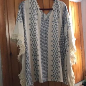 Soft cream poncho with embroidered fringe